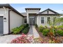 Home's front entrance showcases a walkway with a stone walkway and double doors at 4906 Lighthouse Bay Ln, Bradenton, FL 34211
