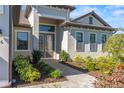 Close up of the entrance featuring double doors, stone walkway and manicured garden at 4906 Lighthouse Bay Ln, Bradenton, FL 34211