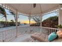 Relaxing gazebo featuring comfortable lounge seating with stunning views of the beach and sunset at 681 Casey Key Rd, Nokomis, FL 34275