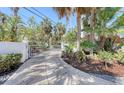 Private gated entrance with lush landscaping at 681 Casey Key Rd, Nokomis, FL 34275