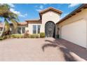 Home exterior showcasing a two-car garage, and a walkway to the front door at 10924 Bullrush Dr, Venice, FL 34293