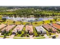 Beautiful aerial view of home, lush landscaping, and stunning lake view in a serene neighborhood at 1330 Still River Dr, Venice, FL 34293