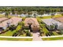 Attractive aerial shot of home showcasing its location with lush greenery and a peaceful lake view at 1330 Still River Dr, Venice, FL 34293