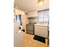 Retro kitchen with light wood cabinets and appliances at 2228 Canal Dr # D26, Bradenton, FL 34207