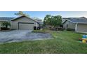 View of the front of the house, including the driveway and landscaping at 3409 Avenida Madera # A, Bradenton, FL 34210