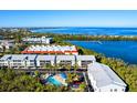 Community view with waterfront access, pool, and lush landscaping at 3601 E Bay Dr # 203, Holmes Beach, FL 34217