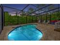 Relaxing kidney-shaped pool with a screened enclosure at 421 Island Cir, Sarasota, FL 34242