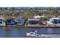 Waterfront property with boat and surrounding houses at 5412 Siesta Cove Dr, Sarasota, FL 34242