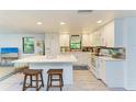 Modern kitchen boasting white cabinets, quartz countertops, and breakfast bar at 7795 Wright Ave, Sarasota, FL 34231