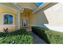 Elegant entryway with a glass door and lush landscaping at 11120 Sanctuary Dr, Bradenton, FL 34209