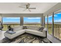 Bright living room with sectional sofa, water views, and ceiling fan at 1333 Perico Pointe Cir, Bradenton, FL 34209