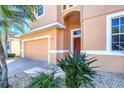 Inviting home exterior with a two-car garage, manicured landscaping, and a charming front entrance at 1800 Scarlett Ave, North Port, FL 34289