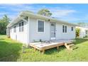 Side view of the house showcasing the wood deck and spacious yard at 208 36Th W St, Bradenton, FL 34205