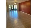 Bright living room with tile floors and sliding glass doors at 435 30Th W Ave # D103, Bradenton, FL 34205