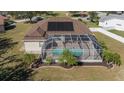 House with solar panels, a screened pool, and lush landscaping at 4569 35Th Avenue E Cir, Palmetto, FL 34221