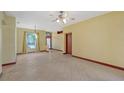 Spacious living room with tile floors and ceiling fan at 5365 Matthew Ct, Sarasota, FL 34231