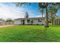 Newly renovated home with brick paver driveway and spacious lawn at 875 Royal Rd, Venice, FL 34293