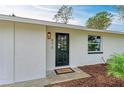 Modern black front door entrance with a welcome mat at 875 Royal Rd, Venice, FL 34293