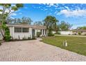 Charming single-story home with manicured landscaping and a brick driveway in a quiet neighborhood at 1097 Willis Ave, Sarasota, FL 34232