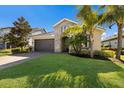 Charming single-Gathering home with a two-car garage, stone facade, and well-maintained front lawn at 12232 Perennial Pl, Lakewood Ranch, FL 34211