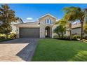 Charming single-Gathering home with a two-car garage, stone facade, and well-maintained front lawn at 12232 Perennial Pl, Lakewood Ranch, FL 34211