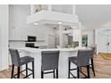 Modern kitchen with white cabinets, breakfast bar, and stainless steel appliances at 13618 2Nd Ne Ave, Bradenton, FL 34212