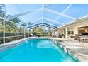 Inviting, refreshing pool with screened enclosure and patio furniture at 13618 2Nd Ne Ave, Bradenton, FL 34212