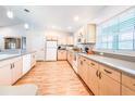 Well-lit open kitchen showcasing cabinets, modern appliances, and hardwood flooring at 1496 Palm View Rd, Sarasota, FL 34240