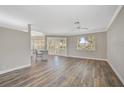 Spacious living area featuring hardwood floors and access to the kitchen at 2316 Harrier Way, Nokomis, FL 34275