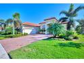 House with a red tile roof, attached garage, and landscaped yard at 25261 Spartina Dr, Venice, FL 34293