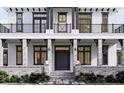 Front entrance of a two-story home with stone and white accents, a balcony, and a double door at 32206 Grand National Drive, Myakka City, FL 34251