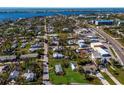 Aerial view showing a small house on a lot with surrounding houses and water at 4420 119Th W St, Cortez, FL 34215