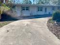 White single story home with driveway and mature landscaping at 5443 Avenida Del Mare, Sarasota, FL 34242