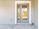 Gray front door with glass panels and white trim at 5533 Gulfport Ter, Port Charlotte, FL 33981