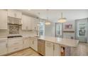 Bright and airy kitchen with an island, modern pendant lighting, stainless appliances, and ample cabinet space at 5548 Summit Gln, Bradenton, FL 34203