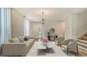 Staged living room with modern decor and an open entryway at 5548 Summit Gln, Bradenton, FL 34203