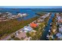 Aerial view showcasing the property's waterfront location and surrounding homes at 598 Lyons Ln, Longboat Key, FL 34228
