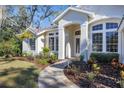 Landscaped walkway leads to the home's front entrance, featuring arched entryway at 6615 Hunter Combe Xing, University Park, FL 34201