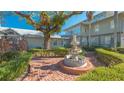 Brick courtyard with fountain and lush landscaping at 1249 S Basin Ln, Sarasota, FL 34242