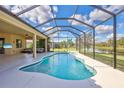 Screened-in pool and patio area overlooking a lake at 17113 1St E Dr, Bradenton, FL 34212