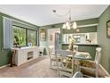 Bright dining area with a glass-top table and white chairs at 1720 Glenhouse Dr # 330, Sarasota, FL 34231