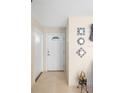 Bright entryway with tile flooring and decorative wall mirrors at 20207 Gladstone Ave, Port Charlotte, FL 33952