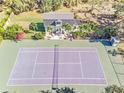 Private tennis court with adjacent guest house and storage shed at 2910 49Th St, Sarasota, FL 34234