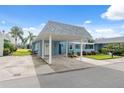 Light blue condo with carport, landscaping, and white pergola at 3856 Trophy Blvd # 2, New Port Richey, FL 34655