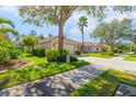 Charming single-story home with well-manicured lawn and mature trees in a sunny neighborhood at 4316 Callista Ln, Sarasota, FL 34243