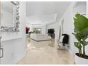 Bright foyer with glossy tile flooring, a modern mirror, and elegant decor at 4316 Callista Ln, Sarasota, FL 34243