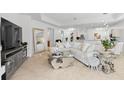 Bright living room featuring a large sectional sofa and stylish coffee table at 4316 Callista Ln, Sarasota, FL 34243