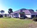 Exterior of house with appealing landscaping and backyard at 4425 Fairway Dr, North Port, FL 34287