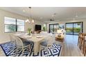 Open concept dining area with wood-look floors and a chandelier at 6043 Bluestar Ct, Bradenton, FL 34211