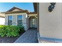 Front entrance with gray stone and a light green door at 6043 Bluestar Ct, Bradenton, FL 34211